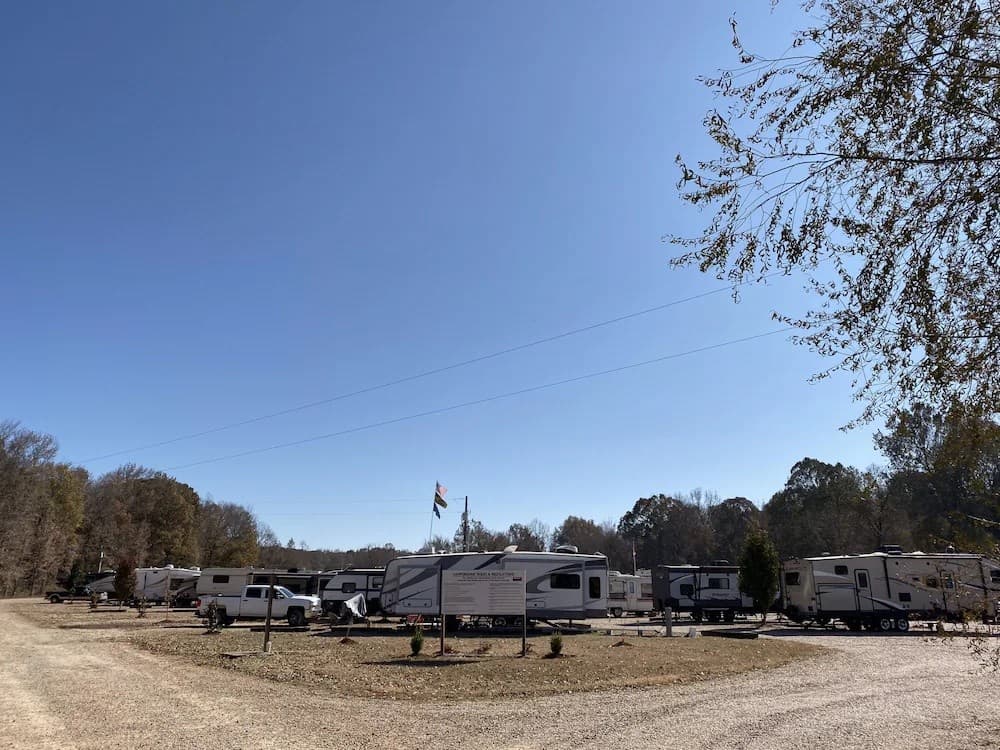 RVs parked at Rebel RV Park with spacious sites and green surroundings