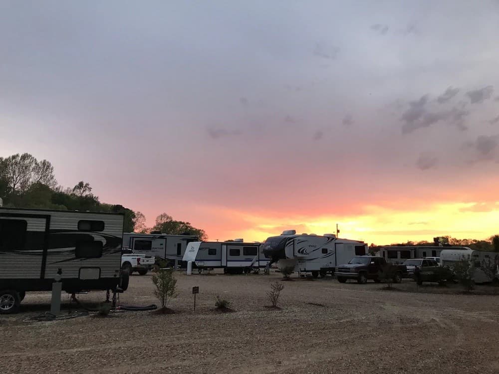 Nighttime scene at Rebel RV Park with RVs illuminated